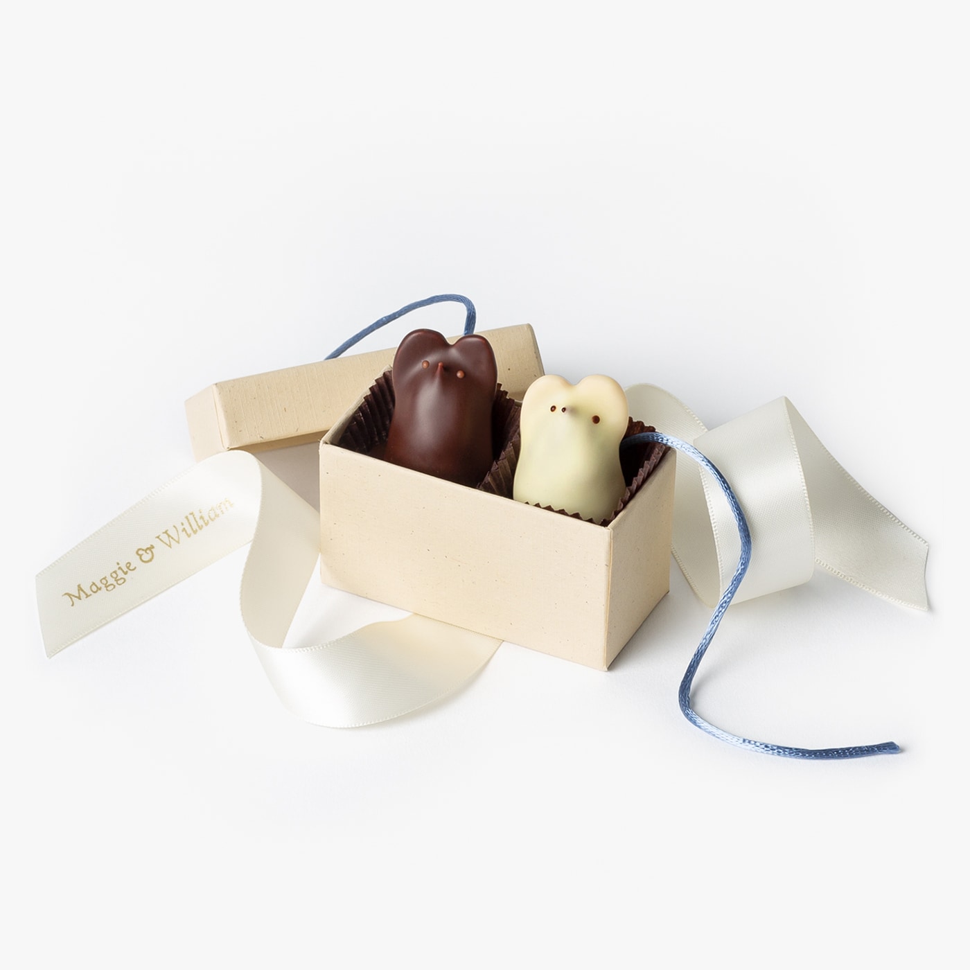 Two chocolate mice in a gift box for a wedding or event favor.